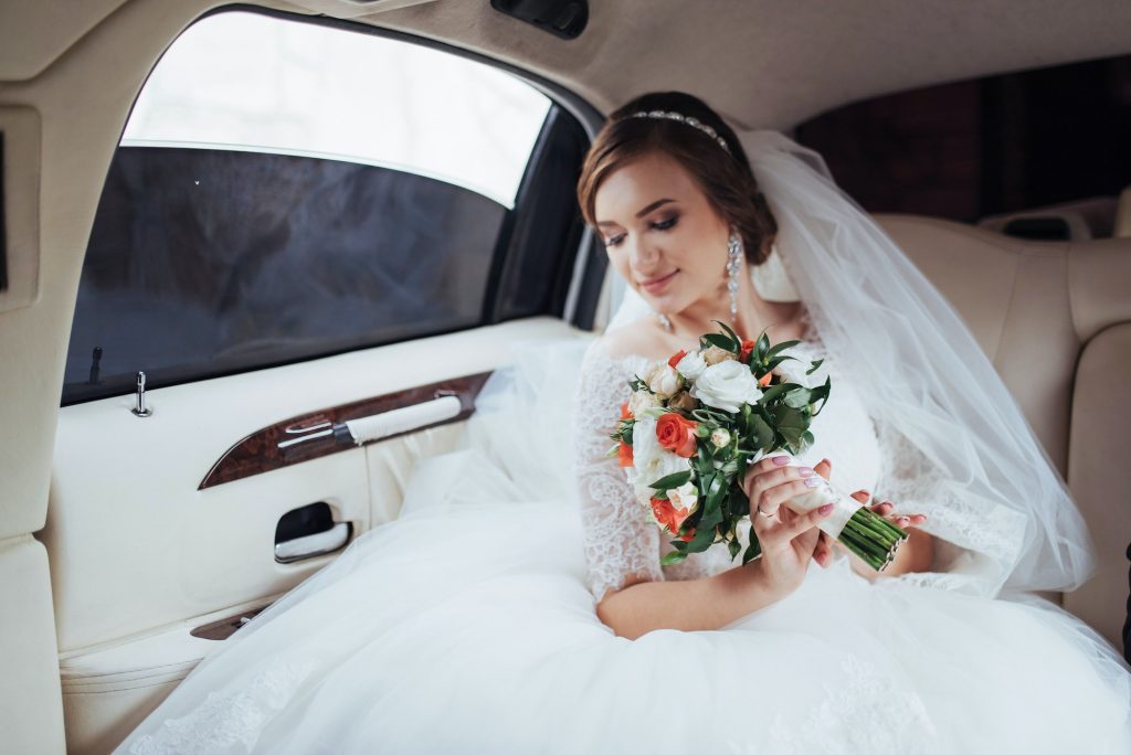 Portrait of a beautiful young bride in the car